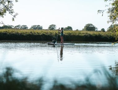 Ellie cruisng on the SUP